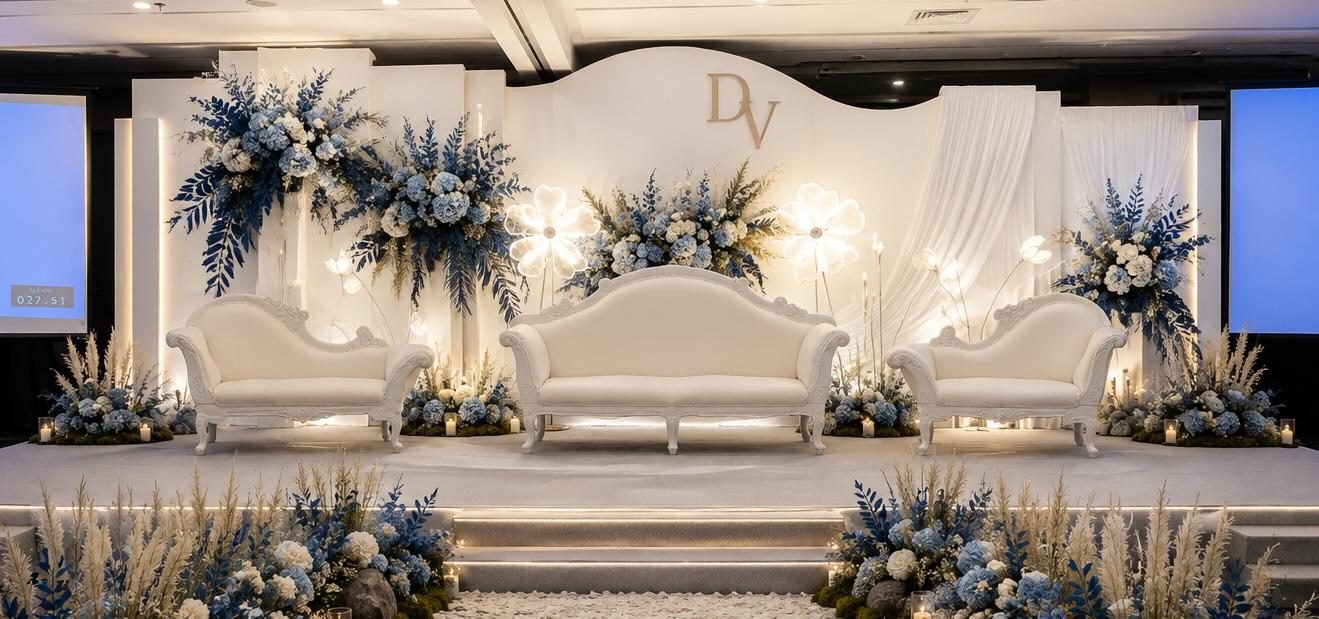 Wide ceremony stage with dusty blue florals and illuminated flower motifs